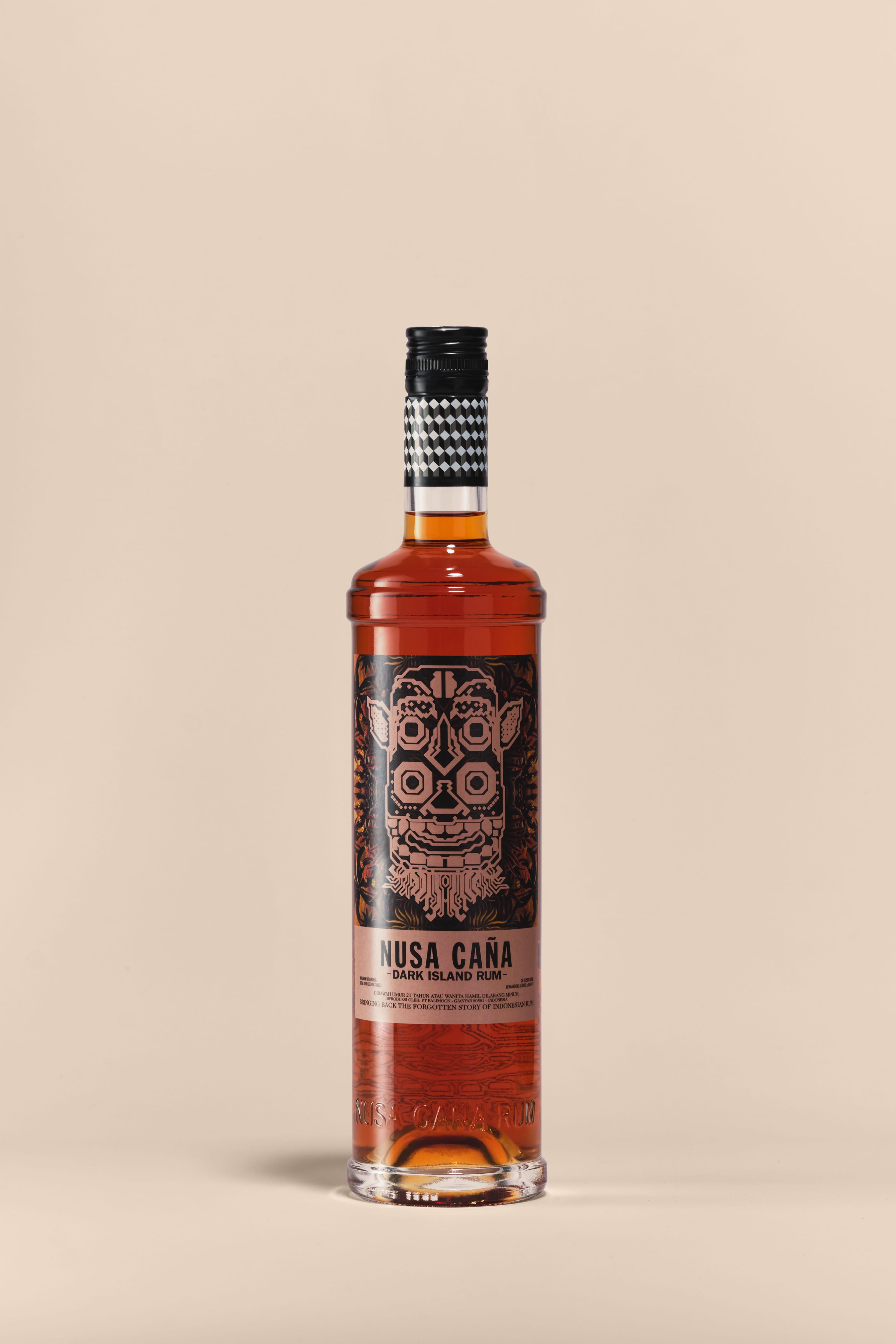 Nusa Caña Dark Island rum bottle with a beige background.